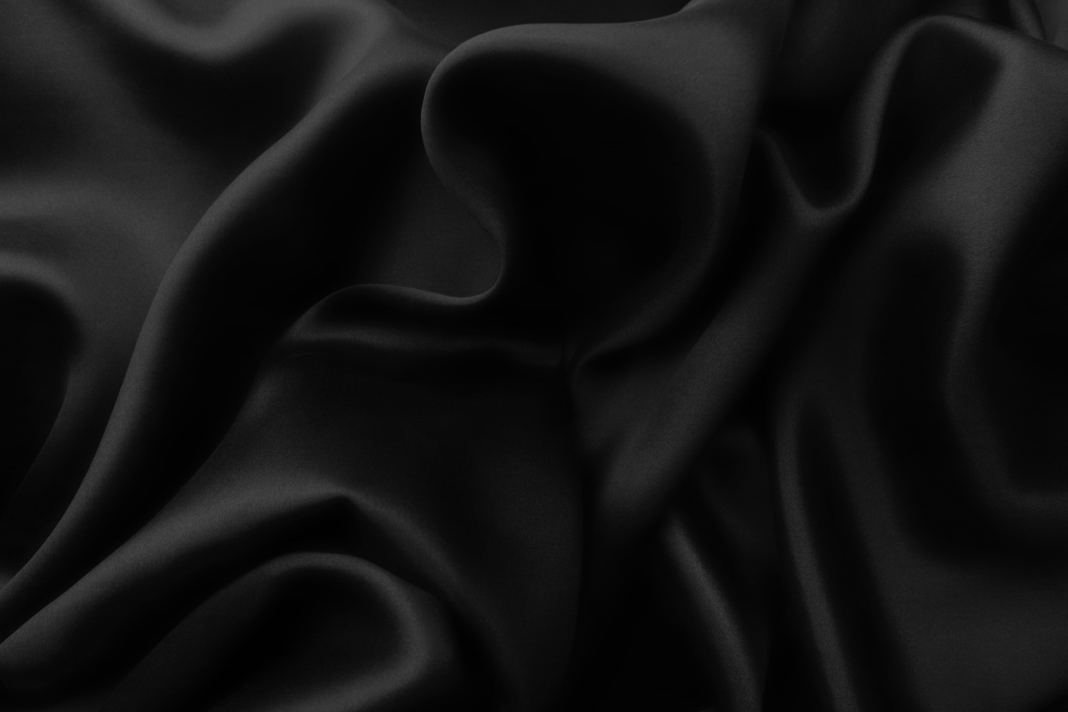 Elegant black soft silk with waves, texture background