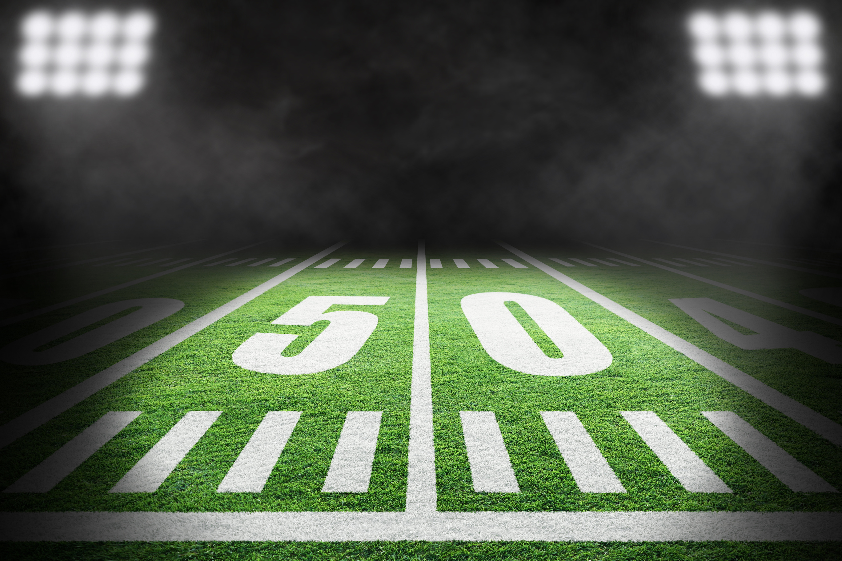 American Football Field With Stadium Lights and Smoke